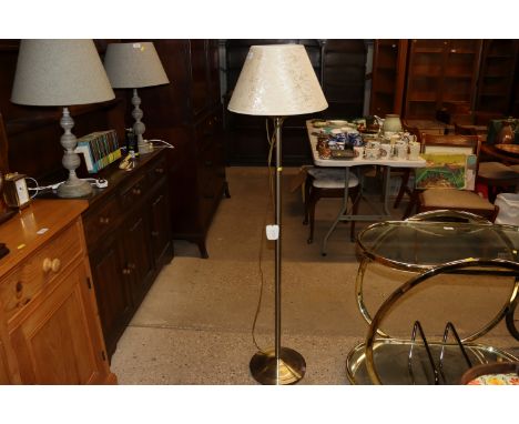 A modern uplighter type standard lamp and shade