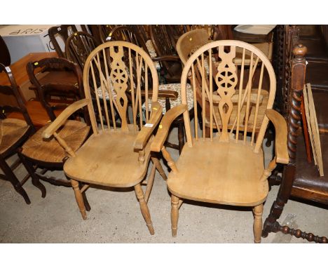 A pair of stick and wheel back elbow chairs and a similar spindle back elbow chair 