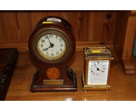 An inlaid balloon cased mantel timepiece with brass presentation plaque; and a Taylor & Bligh carriage clock with presentatio