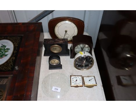 A collection of various 20th Century mantel and alarm clocks; and a clock glass 