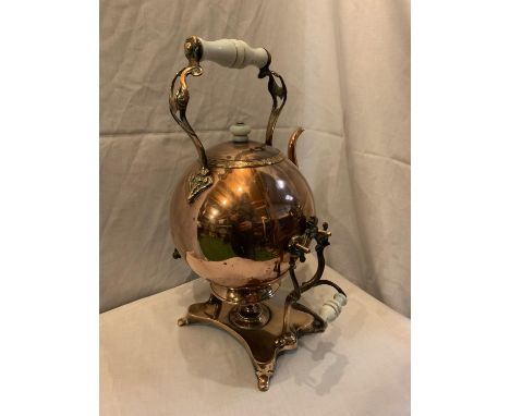 A VINTAGE COPPER KETTLE ON A STAND 