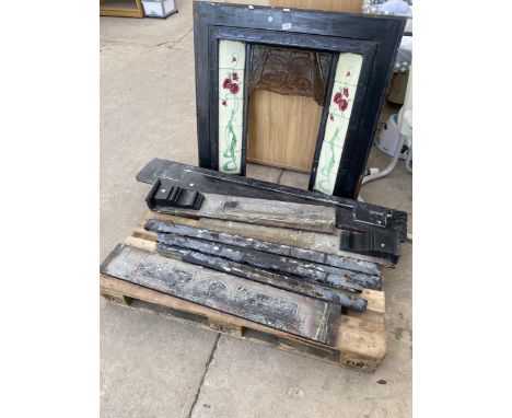 A DECORATIVE CAST IRON FIRE PLACE WITH DECORATIVE TILE SURROUND 