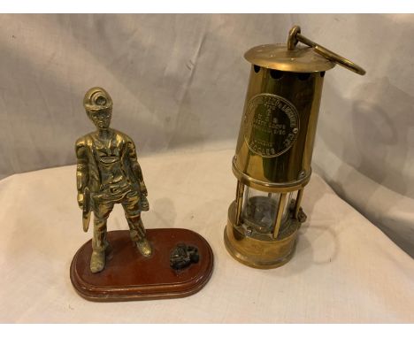 A HEAVY BRASS SAFETY LAMP AND A BRASS MINER WITH COAL ON A PLINTH 