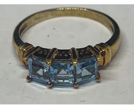 A 9 CARAT GOLD RING MARKED 375 WITH THREE IN LINE SWISS BLUE TOPAZ STONES SIZE N GROSS WEIGHT 2.4 GRAMS IN A PRESENTATION BOX