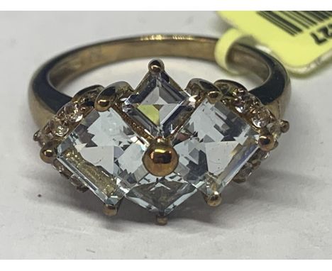 A MARKED 9K GOLD RING WITH PALE BLUE DIAMOND SHAPED STONES AND FIVE CLEAR STONES ON EACH SHOULDER SIZE O GROSS WEIGHT 3.7 GRA