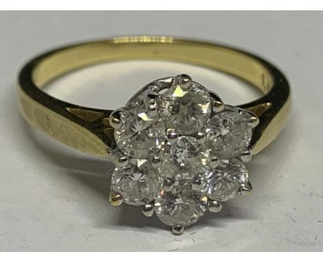 AN 18 CARAT YELLOW GOLD RING WITH 1 CARAT OF DIAMONDS IN A SEVEN STONE FLOWER DESIGN SIZE O/P IN A PRESENTATION BOX 