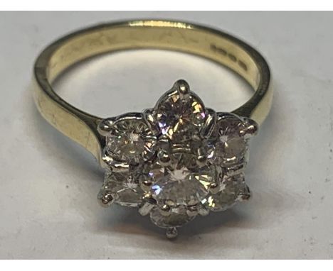 AN 18 CARAT GOLD RING WITH SEVEN MANUFACTURED DIAMONDS IN A FLOWER DESIGN SIZE M IN A PRESENTATION BOX 