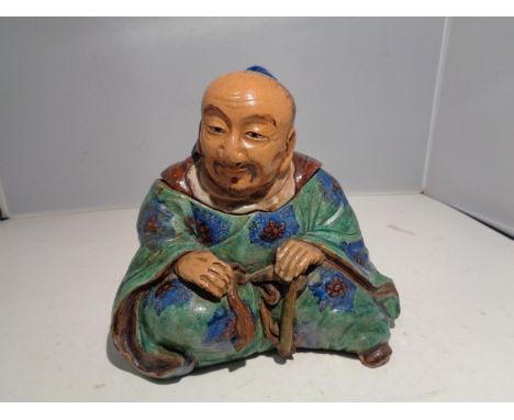 A TEA CADDY IN THE FORM OF A CHINA MAN, MARKED UNDERNEATH 