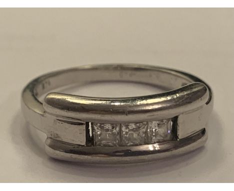 A 9 CARAT WHITE GOLD RING WITH THREE IN LINE CLEAR STONES GROSS WEIGHT 3.2 GRAMS SIZE M 