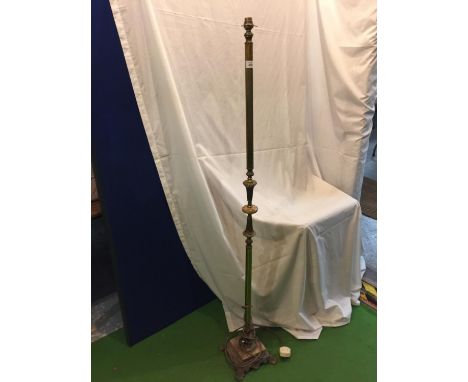 A BRASS STANDARD LAMP ON A COLUMN STYLE UPRIGHT WITH A FOOTED BASE 