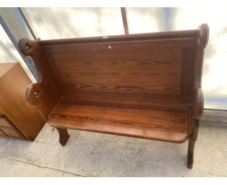 A VICTORIAN PITCH PINE PEW WITH HINGED SEAT REVEALING HYMN BOOK SHELF 