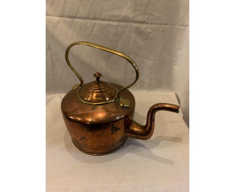A VINTAGE COPPER AND BRASS KETTLE 