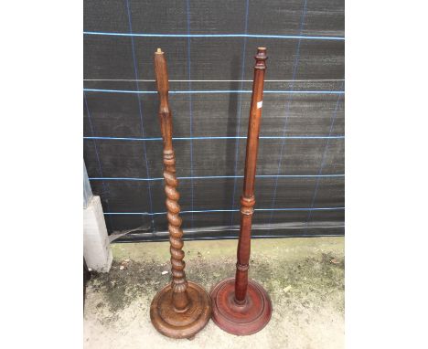 AN OAK BARLEYTWIST STANDARD LAMP AND TURNED BEECH STANDARD LAMP 