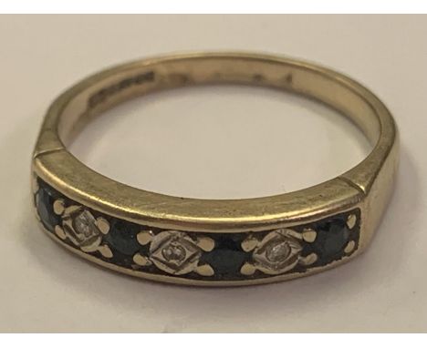 A 9 CARAT GOLD RING WITH FOUR SAPPHIRES AND THREE DIAMONDS IN LINE SIZE O 