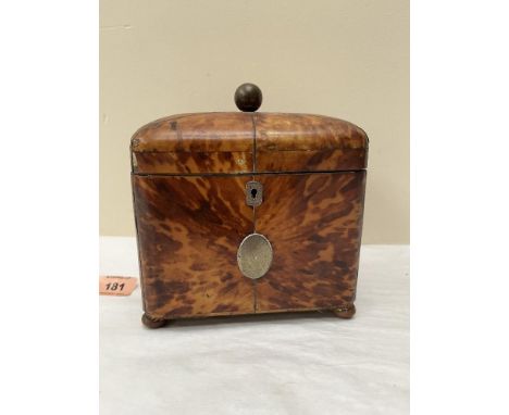 A George III tortoisehell tea caddy, the domed lid enclosed two lidded compartments, raised on bun feet (one a replacement). 