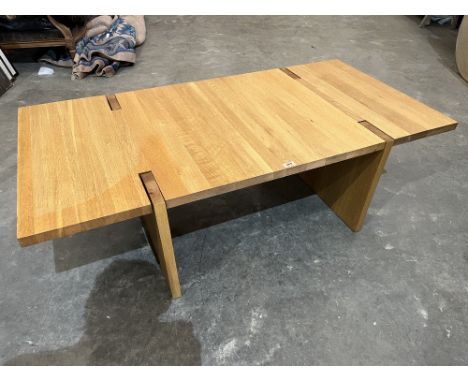 A contempory style light oak coffee table. 56' long