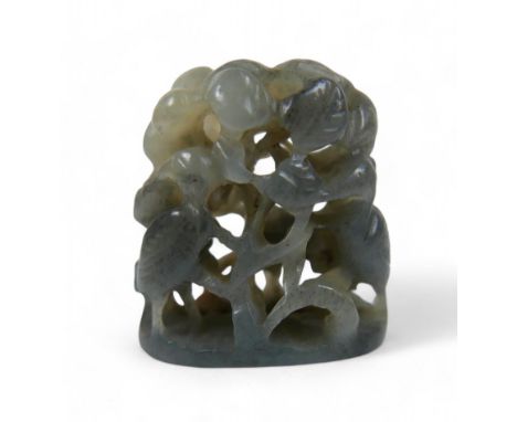 A carved Chinese jade finial, possibly 18th century, depicting a forest scene, deeply carved in openwork with a deers and cra
