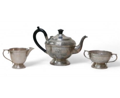 A George V and later silver bachelor's associated three-piece tea service, comprising a teapot with bakelite finial and handl