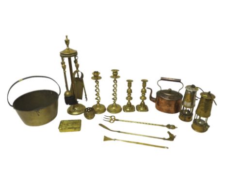 A collection of brass and copper items, comprising two miners lamps, a Princess Mary 1914 WWI tin, candlesticks, jam pan, com