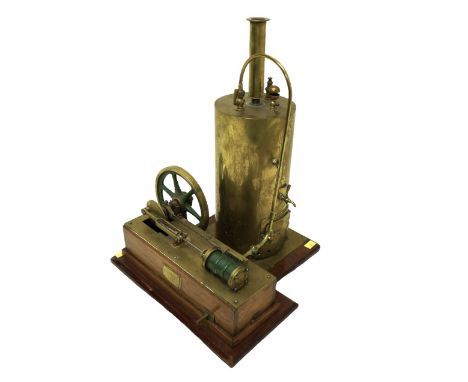 A vertical cylinder static steam engine, with piston driven wheel, 26 by 26 by 36cm high. 