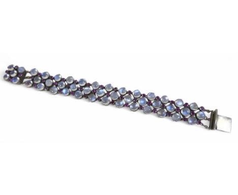 A vintage moonstone and ruby bracelet, made up of 44 moonstones, each 6.5mm diameter, and 43 small rubies, with push clasp, b