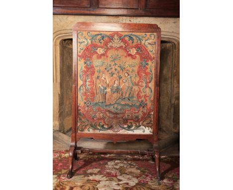 A GEORGE I WALNUT CHEVAL FIRESCREEN the petit point panel of figures in a landscape in a cartouche-shaped panel incorporating