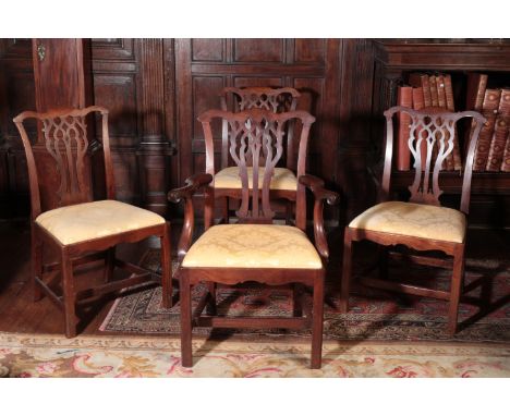 A GEORGE III ELBOW CHAIR of Chippendale design, the serpentine cresting rail over pierced vase splats and a drop-in seat, ove