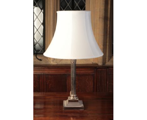 A SILVER-PLATED CORINTHIAN COLUMN TABLE LAMP the square base stamped "GS", fitted for electricity and with a cream-coloured s