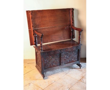 A CHARLES II OAK BENCH TABLE circa 1660 and later, with shaped arms on baluster supports over a rectangular seat with a mould