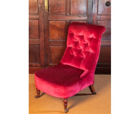 A VICTORIAN OCCASIONAL CHAIRwith a swept button back and a compass-shaped seat, on turned front legs ending in brass toe caps