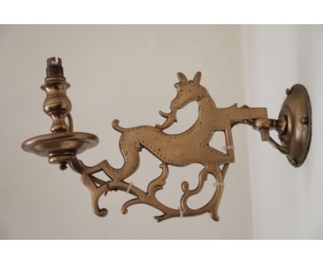 A BRASS WALL LIGHT with two arms designed as running deer, fitted for electricity; and two other wall lights, each with a sin