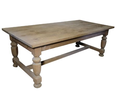 A VICTORIAN STYLE PINE KITCHEN TABLE on turned legs joined by an "H"-stretcher, 214cm x 104.5cm; and a pine bench with shaped