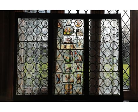 A LEADED LIGHT WINDOW&nbsp;in three sections, the central panel incorporating stained glass panels of goats, George and the d