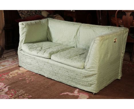 A KNOLE STYLE SOFAwith upholstery and loose covers in pale green jade figured damask, one end hinged and dropping down to for