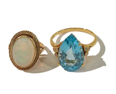 A 9 carat gold opal ring, finger size E; and a blue topaz and diamond ring, unmarked, finger size S (2)Condition report: Opal