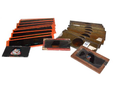 A collection of eight magic lantern slides in gilt and black tin slips; a set of twelve magic lantern slides; and three other