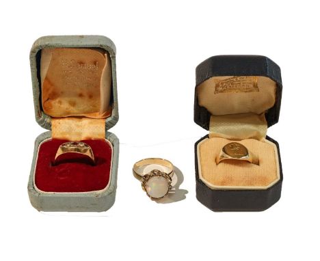 An opal and diamond ring, stamped '9CT', finger size P; a signet ring, stamped '18', finger size I; and a 9 carat gold garnet