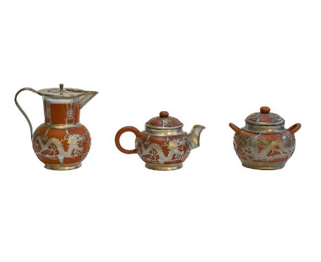 A 20th century Chinese three-piece pewter mounted Yixing tea service