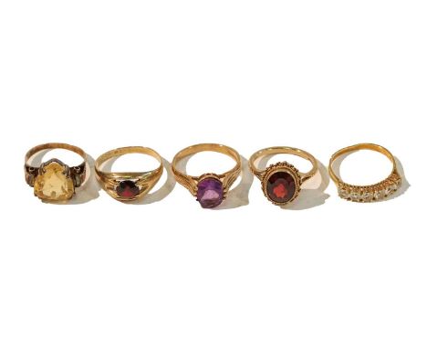 Two 9 carat gold garnet rings, finger sizes M1/2 and O1/2; a 9 carat gold amethyst ring, finger size P; together with a citri