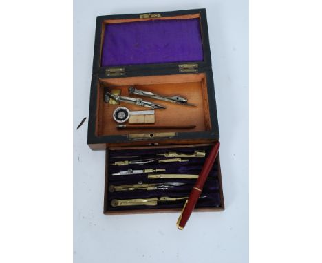 An early 20th century cased geometry drawing set together with a 14k nib Parker fountain pen.