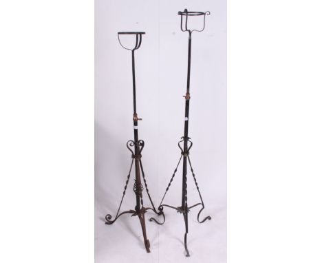 A near pair of early 20th century cast iron rococo oil lamp stands. Rococo wrought iron frames with adjustable telescopic ste