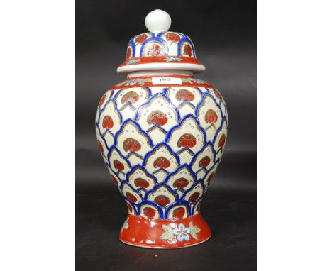 A 20th century stoneware ceramic jar, with lid. Highly decorated all over. No makers marks. H34cm
