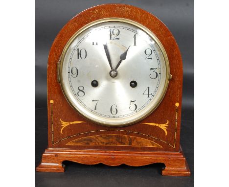An Edwardian mahogany inlaid 8 day mantel clock in working order complete with the key. 8 day movement with ceramic face
