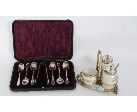 A cased set of teaspoons with faux bamboo spoons along with a ceramic condiment set on silver plate base