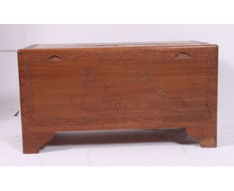 A 1950's camphor trunk of Chinese origin with hinged top and carved decoration having open storage set within. H48 W91 D45cm