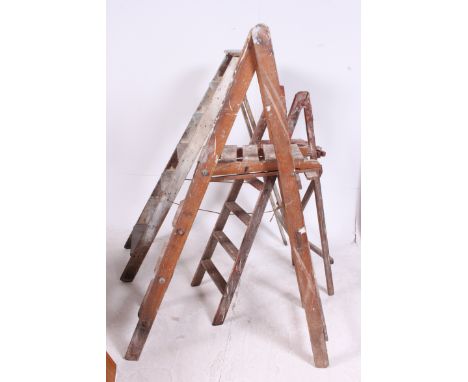 A collection of 20th century Industrial Three vintage wooden step ladders