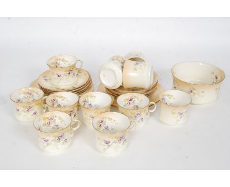 An early 20th century Ivory blush and chintz pattern part tea service comprising cups, saucers plates etc. Stamped to undersi