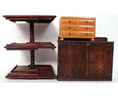 A vintage pipe rack along with a miniature chest of drawers and a revolving table top stand H30cm