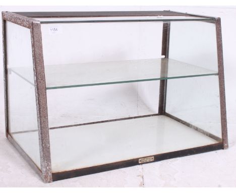 A vintage haberdashery / counter top glass display cabinet of angular form complete with the original retailers label