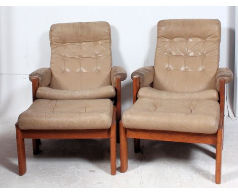 A  pair of retro 1970's Norwegian teak and cream leather armchairs by Ekornes. The teak show wood frames with original cream 